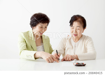 Senior women and middle women filling in documents 20840415
