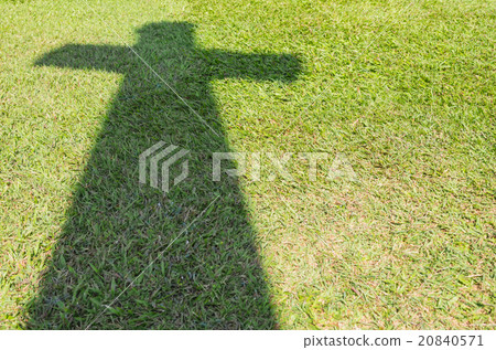 Shadow of Christian cross on green grass floor Shadow of Christian cross on green grass floor 20840571