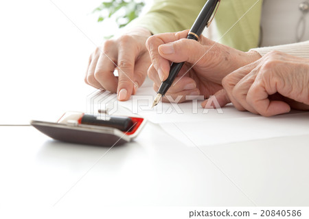 Senior woman who fills in the document and middle female elderly sign autographed without face 20840586
