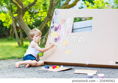 Little kid boy painting big paper house with Little kid boy painting big paper house with 20846062