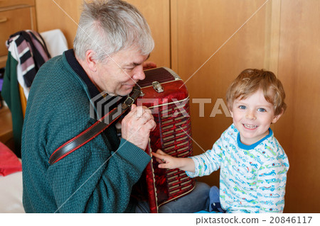 Little kid boy and grandfather playing music Little kid boy and grandfather playing music 20846117