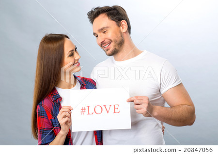 Nice young couple holding shit of paper Nice young couple holding shit of paper 20847056