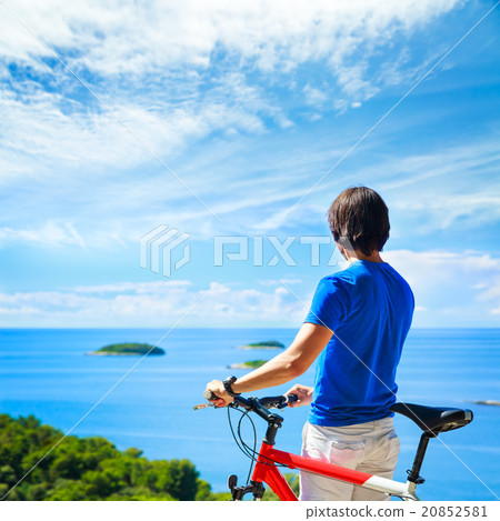 Man with a Bike on Beautiful Nature Background 20852581