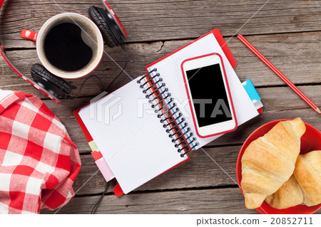 Fresh croissants, coffee, phone and headphones 20852711
