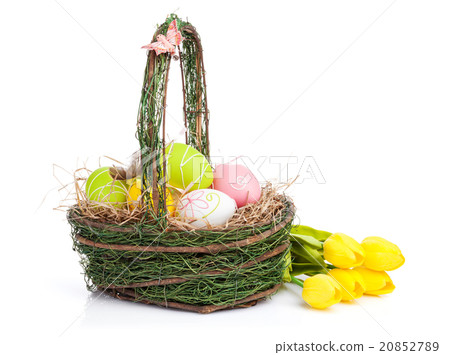Easter eggs basket and yellow tulips 20852789