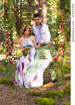 Beautiful couple on flower swing. 20852986