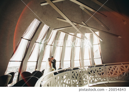 wedding couple is standing and kissing in hotel 20854843