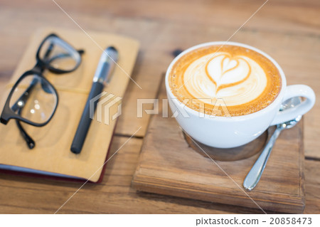 Hot latte art coffee cup on wooden table  20858473