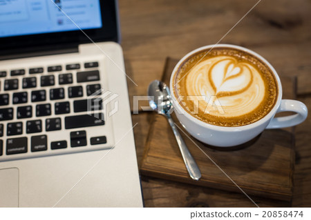 Coffee cup and laptop on wood table background. Coffee cup and laptop on wood table background. 20858474