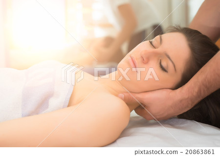 Therapist massaging the neck of woman 20863861