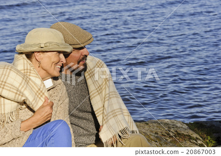 senior couple by lake blanket around shoulders senior couple by lake blanket around shoulders 20867003