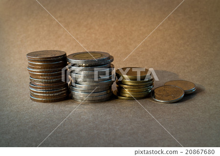coin stack on brown background 20867680