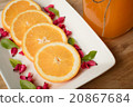 slice orange in dish on wood table 20867684