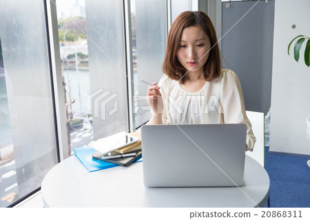 A woman smoking a cigarette 20868311