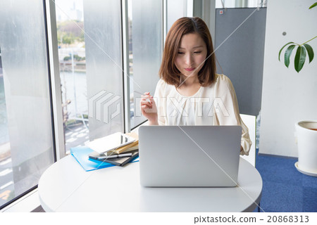 A woman smoking a cigarette 20868313