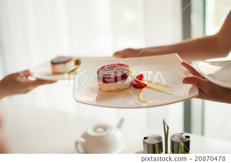 Waiter takes a plate of dessert Waiter takes a plate of dessert 20870478