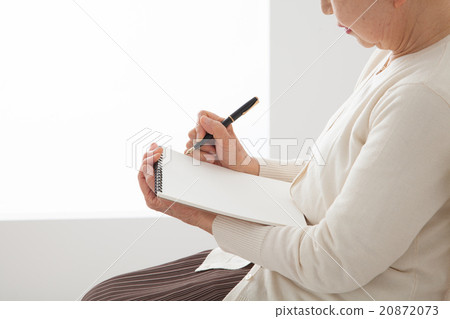 Sitting on a chair and writing notes Senior women Ending notes Myself History up Sitting on a chair and writing notes Senior women Ending notes Myself History up 20872073