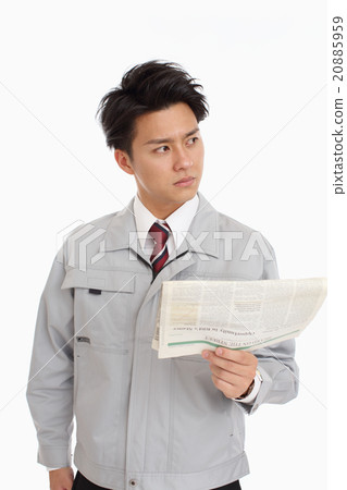 A man reading uniforms reading an English newspaper A man reading uniforms reading an English newspaper 20885959