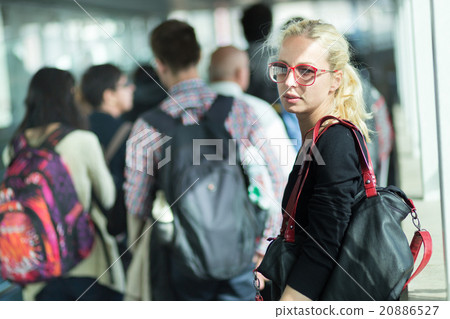 Young blond caucsian woman waiting in line. 20886527