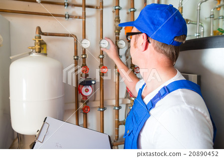 Engineer controlling the heating system 20890452
