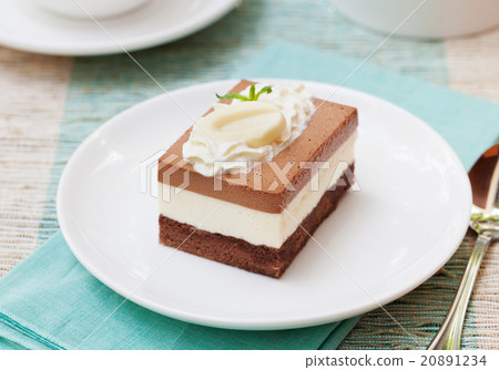 Three chocolate mousse cake on a white plate 20891234