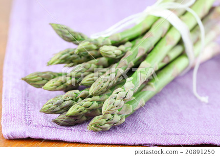 Green asparagus on purple napkin 20891250