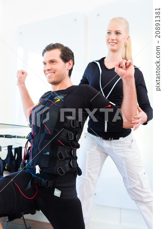 Man having ems training with personal trainer 20891381