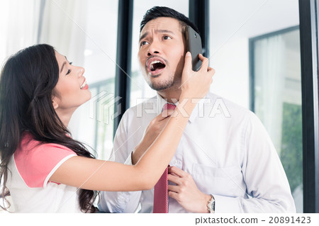 Man already using phone for business leaving home Man already using phone for business leaving home 20891423