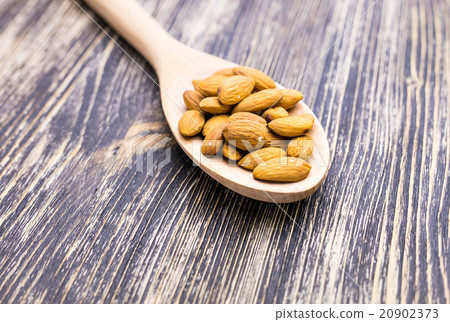 Almonds in wooden spoon Almonds in wooden spoon 20902373