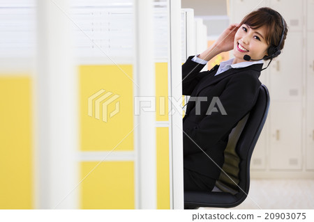 young beautiful business woman with headset in office young beautiful business woman with headset in office 20903075