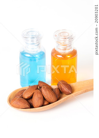 Almonds on wood and oil bottle Almonds on wood and oil bottle 20903201