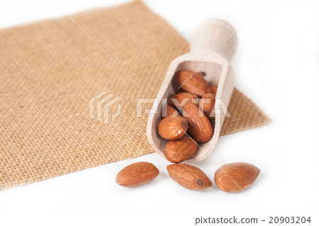 almonds in wood spoon almonds in wood spoon 20903204