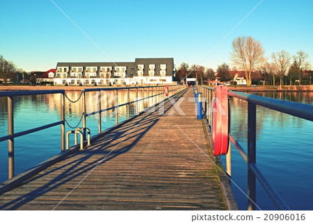 Wharf scaffold above  sea at harbor.House on coast 20906016