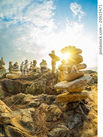 Stones pyramid on sand symbolizing zen Stones pyramid on sand symbolizing zen 20915471