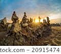 Stones pyramid on sand symbolizing zen 20915474