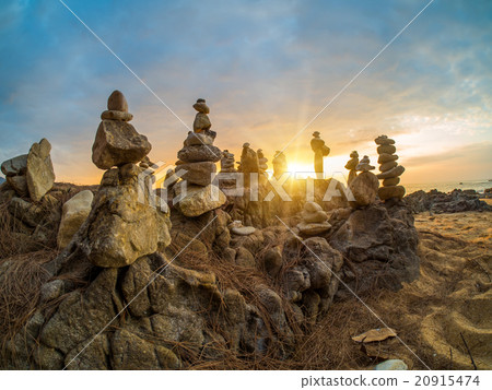 Stones pyramid on sand symbolizing zen 20915474