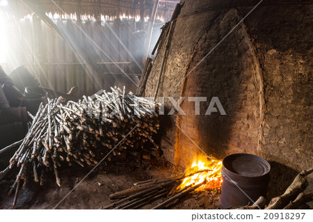 Pile of slow burning wood at charcoal factory 20918297