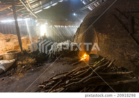 Pile of slow burning wood at charcoal factory 20918298