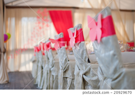 chairs in white covers with a red ribbon chairs in white covers with a red ribbon 20929670