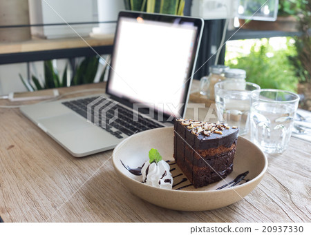 cake chocolate on wood table work with laptop cake chocolate on wood table work with laptop 20937330