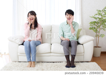 A couple sitting on the sofa 20940839