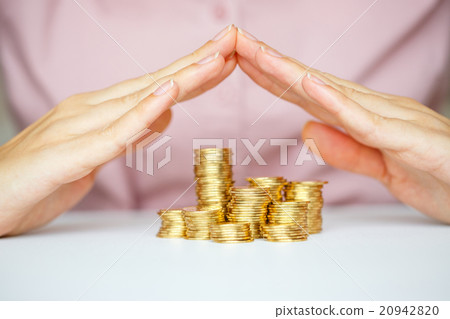 Protect business start-up concept - with hands and coin Protect business start-up concept - with hands and coin 20942820