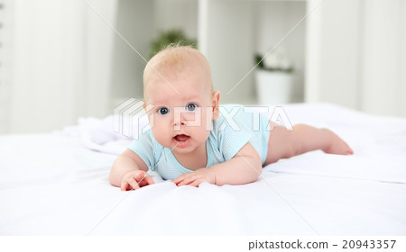 happy newborn baby on bed 20943357
