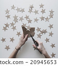 Woman's hands cut stars of craft paper 20945653
