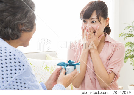 A young woman gets a present for her grandmother 20952039
