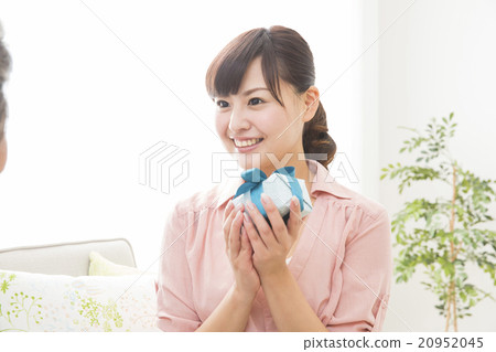 A young woman gets a present for her grandmother A young woman gets a present for her grandmother 20952045