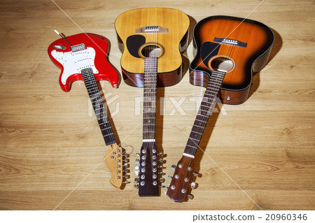three guitars are on the floor 20960346