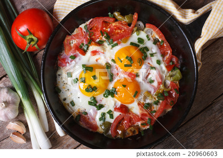 Fried eggs with vegetables on a pan Fried eggs with vegetables on a pan 20960603