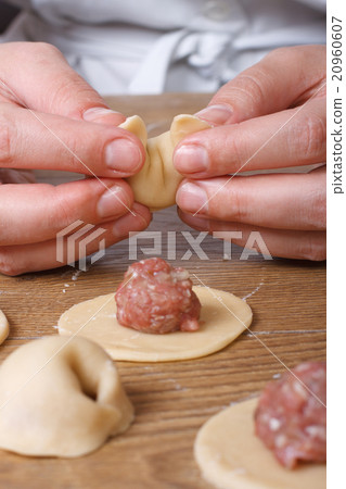 Hands cooks prepare dumplings close-up vertical Hands cooks prepare dumplings close-up vertical 20960607
