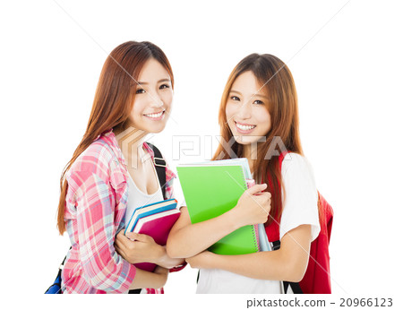Two happy teenage students girls isolated on white Two happy teenage students girls isolated on white 20966123